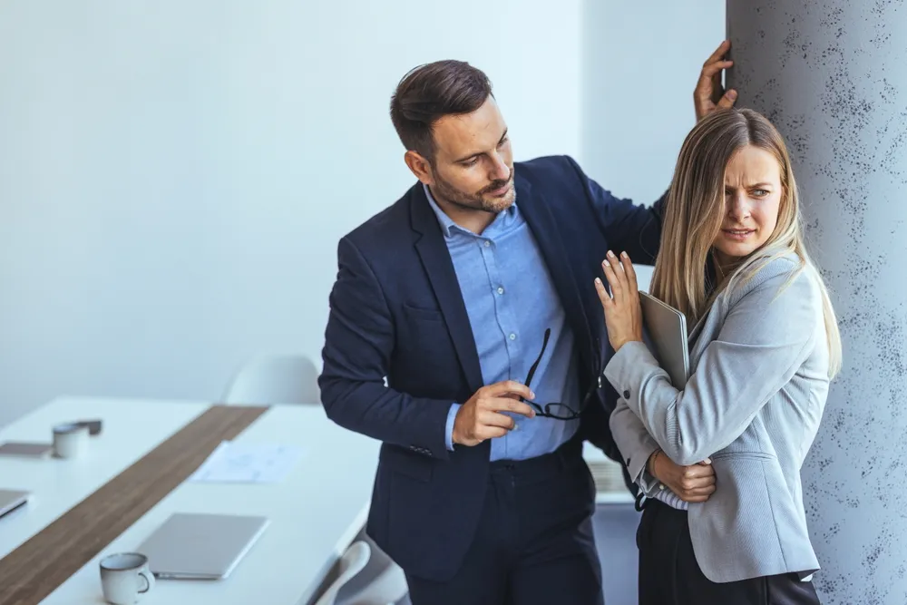 A woman raising her hand to stop a shadowy figure behind her, symbolizing resistance and rejection.