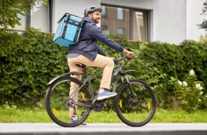 A courier riding a bicycle.